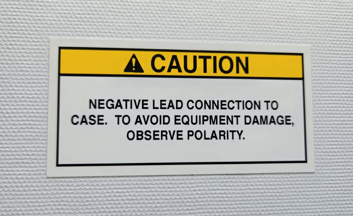 Negative Lead Connected to Case Caution Label (2) (our #127)